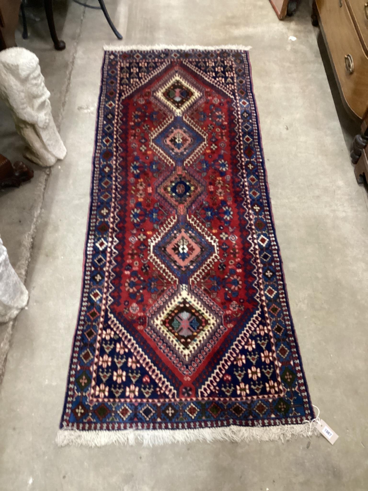 A Caucasian style red ground runner 200cm x 76cm